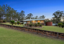 Flat and flood free acreage with well-positioned home